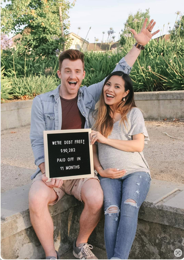A couple celebrating after paying off debt